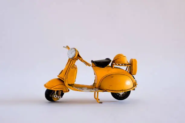 Photo of Old toy vespa motorbike on different backgrounds