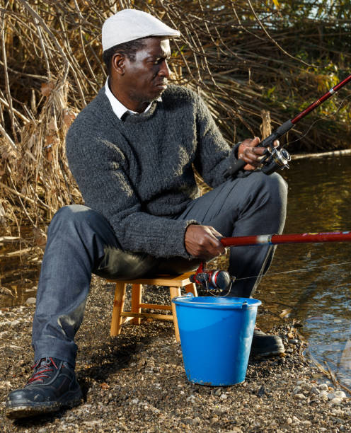 istock Man fishing with rods on river 1299059293