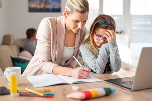 istock Mother and daughter learning together at home 1299060037