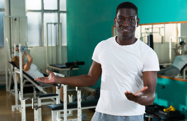 istock Friendly afro man welcoming to gym 1299060865