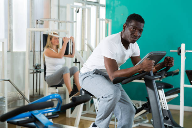 istock Man and women exercising on simulators 1299060873