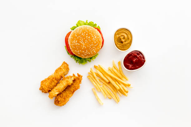 istock Fast food flat lay set. Burger with fried potatoes and chicken, top view 1299061100