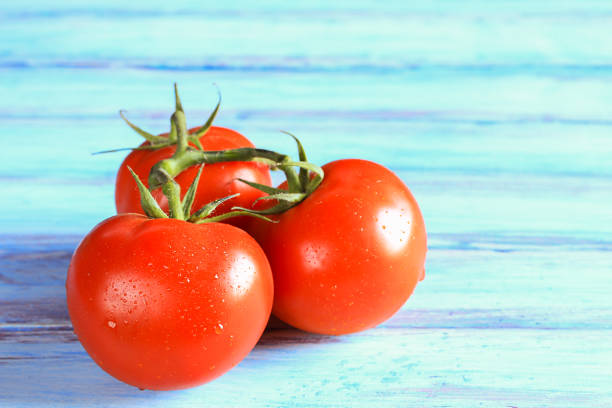istock Close up fresh red tomato on wooden table 1299062781