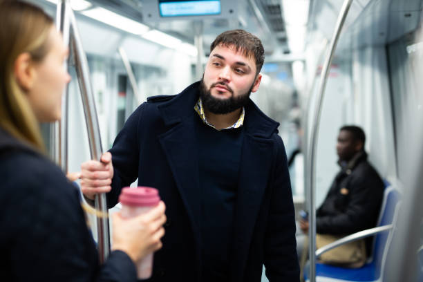 istock Young man talking with woman in subway 1299062849