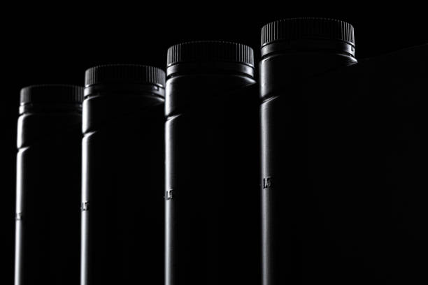 istock Engine oil bottle on black background, close up. 1299063859