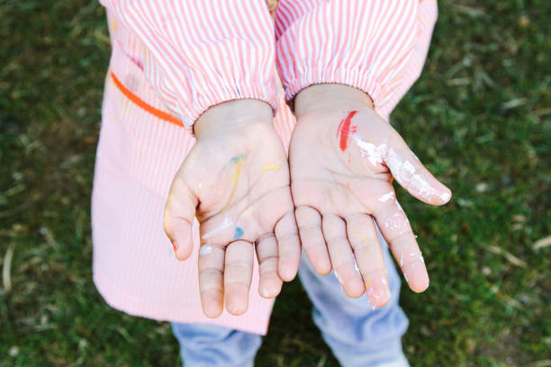 istock Child hands with colorful paint 1299063938