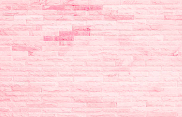 istock Empty Pink brick wall texture background in the bedroom at lovely. Brickwork stonework interior, rock old clean concrete grid uneven abstract weathered brick design, horizontal architecture wallpaper. 1299065008