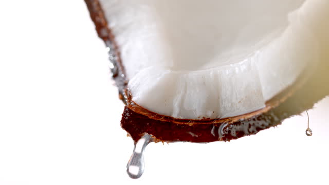 SLO MO LD A single droplet falling from a piece of fresh coconut