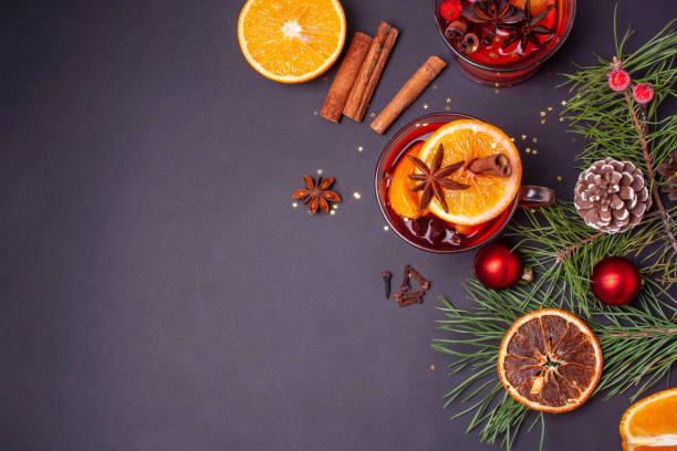 istock Two glasses with mulled wine on a gray background. Christmas decor. View from above 1299068037