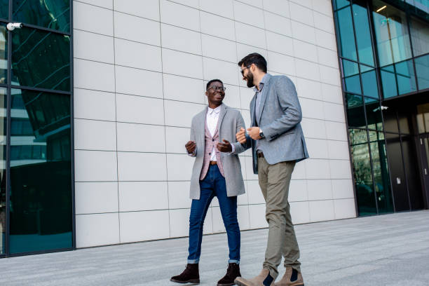 istock Two colleagues talking outdoors 1299068212
