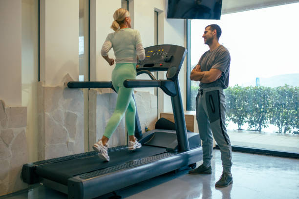 istock Senior Woman Running On Treadmill 1299068270