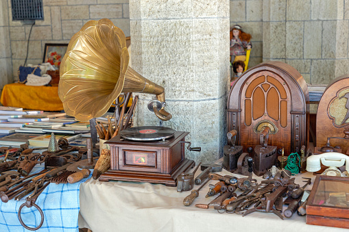 San Marino - June 16, 2019: Antique Turntable and Old Radios at Sunday Market in Republic of San Marino.