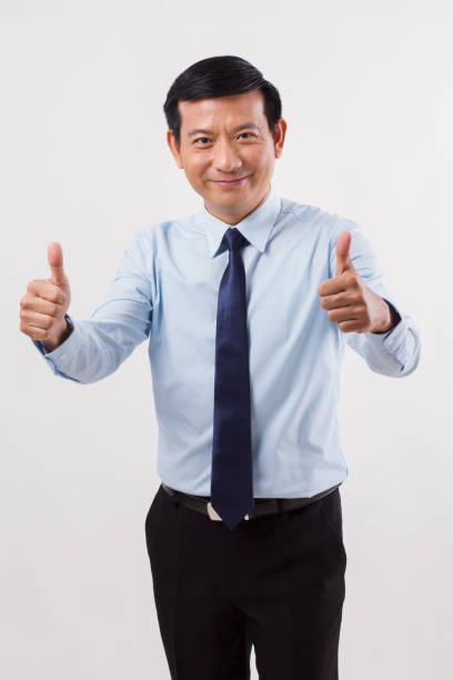 istock businessman pointing up thumb up gesture 1299070517