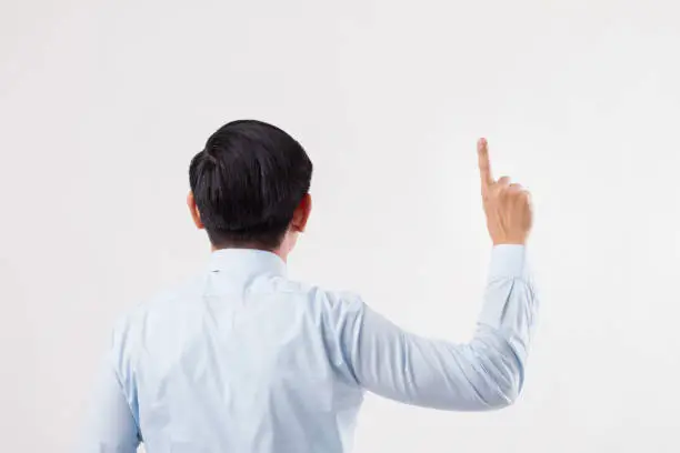 Photo of back of business man pointing up to blank space