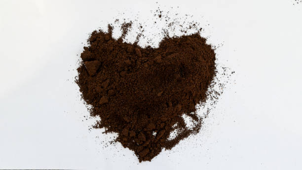 istock Heart shaped coffee grounds for Valentine's Day on a white background. 1299072113