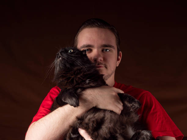 istock Young guy in a red t-shirt looks at camera 1299072278