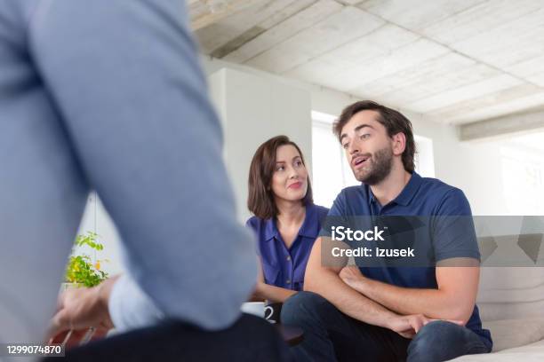 Couple Discussing Problems With Psychotherapist Stock Photo - Download Image Now - Couple - Relationship, Mental Health Professional, 30-39 Years