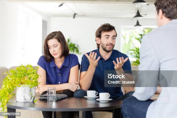 Couple Discussing With Financial Advisor Stock Photo - Download Image Now - 30-39 Years, Adult, Adults Only