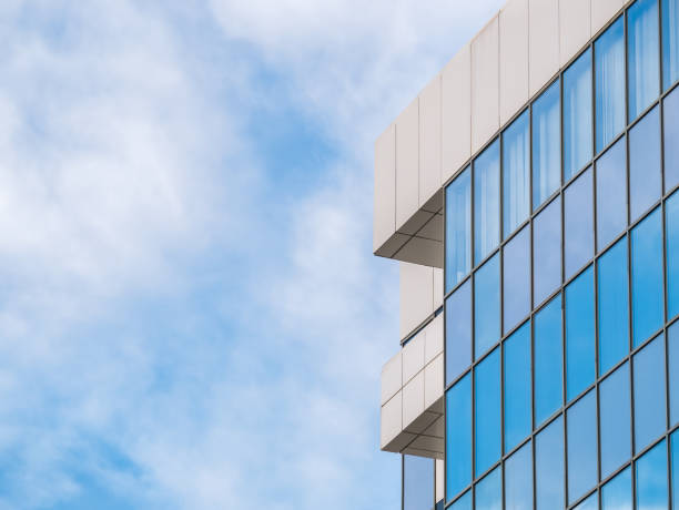 istock Modern glass office building agaist the cloudy sky. 1299075965