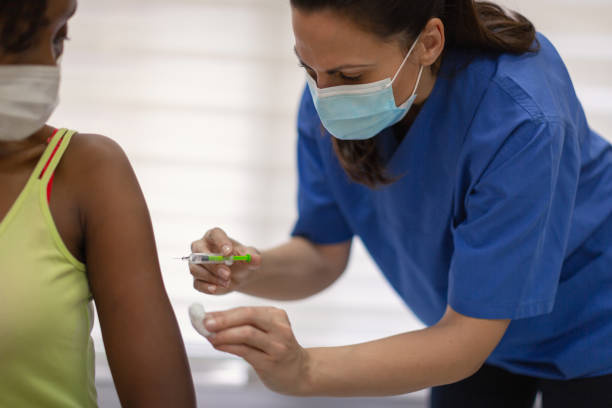 istock African-American female taking a COVID-19 vaccine 1299076520