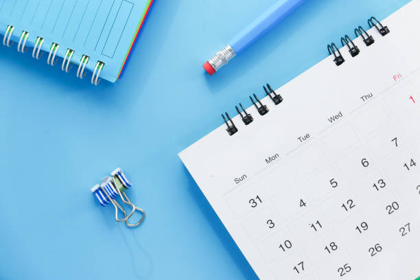 istock deadline concept with stack of calendar and pencil on color background 1299077248