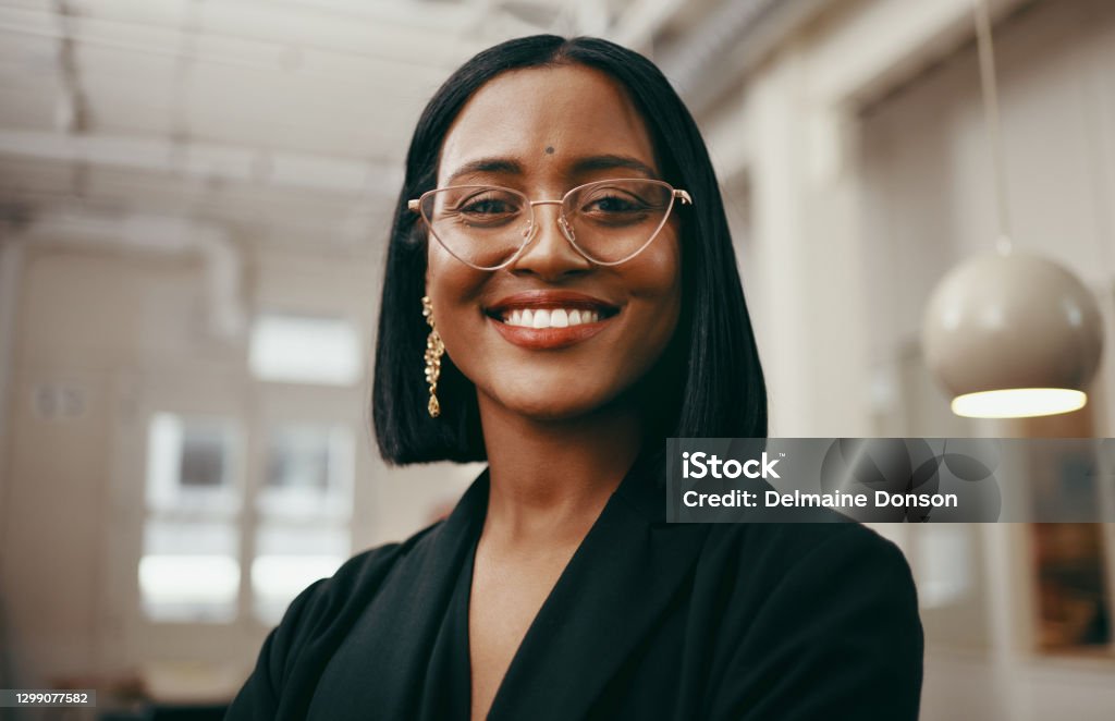 Positivity puts you in a position of power Portrait of a confident young businesswoman working in a modern office Headshot Stock Photo