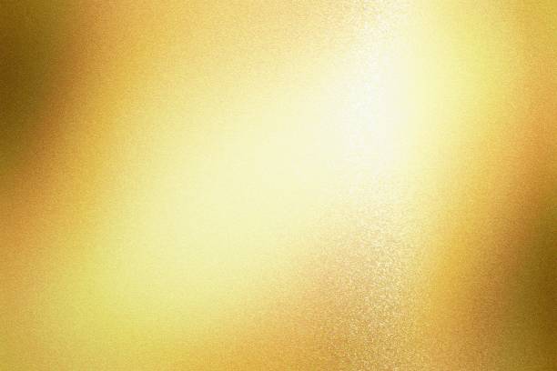 istock Light shining on gold foil glitter metallic wall with copy space, abstract texture background 1299077921