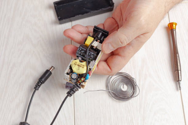 istock Repairing the laptop's power supply 1299078563