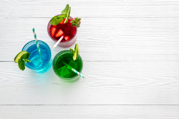 Cold green, blue and red cocktails with fresh fruits and mint