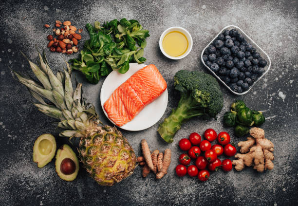 Anti inflammanory diet food Anti inflammatory diet concept. Set of foods that help to reduce inflammation - plant based ingredients, fresh fruit, green vegetables. Healthy diet products, top view, stone background. Toned anti inflammatory stock pictures, royalty-free photos & images