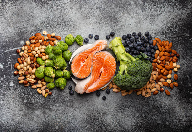 Food for healthy brain Assorted food for brain health and good memory: fresh salmon, vegetables, nuts, berries on stone background. Healthy fresh products to boost brain power, top view animal brain stock pictures, royalty-free photos & images