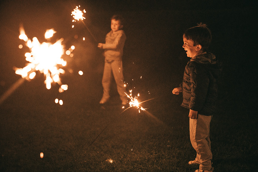 Boys holding sparklers for New Year's Eve