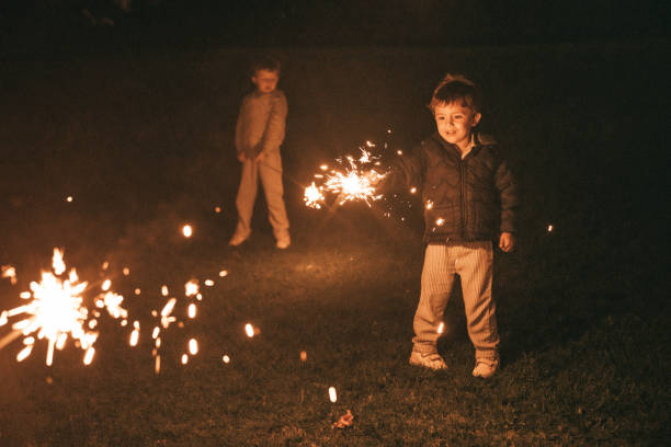 istock Boys holding sparklers for New Year's Eve 1299079979