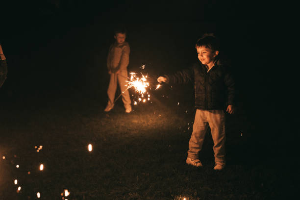 Boys holding sparklers for New Year's Eve