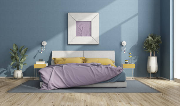 Colorful double bed in a modern room with blue walls
