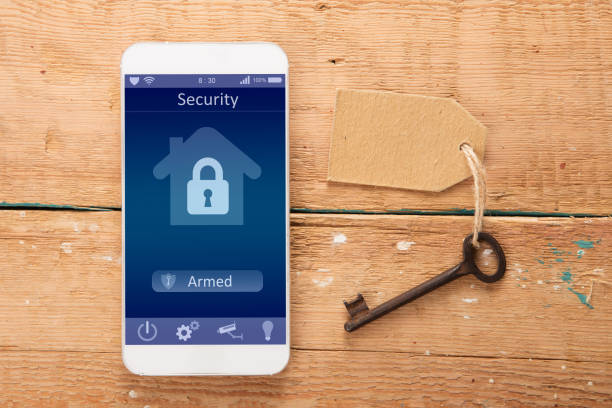 istock Smartphone with smart home app on the wooden desk 1299080900