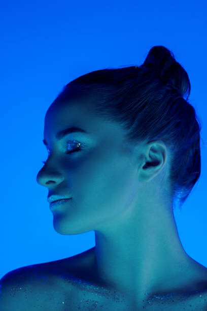 istock Handsome woman's portrait isolated on blue studio background in neon light, monochrome 1299081519