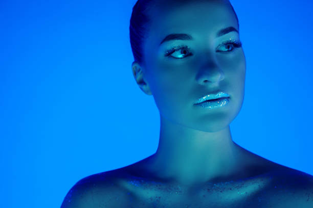 istock Handsome woman's portrait isolated on blue studio background in neon light, monochrome 1299081521