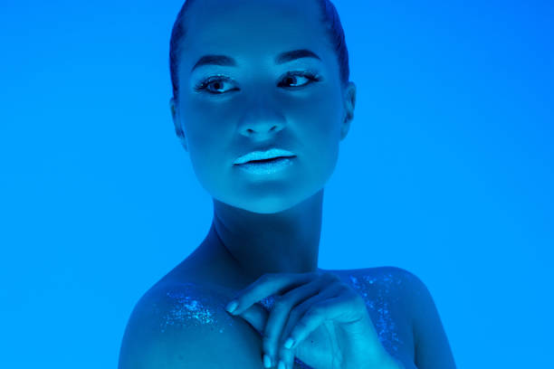 istock Handsome woman's portrait isolated on blue studio background in neon light, monochrome 1299081522