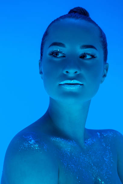 istock Handsome woman's portrait isolated on blue studio background in neon light, monochrome 1299081529
