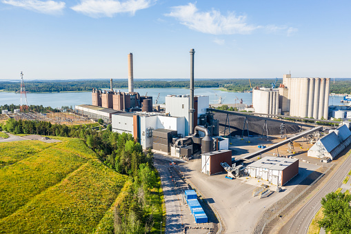 NAANTALI, FINLAND - 27/06/2020: Aerial view of the old coal plant and the new combined power and heat plant in Naantali, Finland. The new plant uses 60-70 percent biofuels to generate power.
