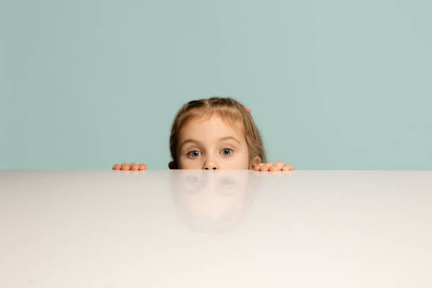 istock Happy kid, girl isolated on blue studio background. Looks happy, cheerful, sincere. Copyspace. Childhood, education, emotions concept 1299085203