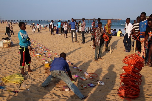 Lomé, Togo - June 30, 2019: People play quoits and throw rings on the beach of Lomé, the capital of Togo, West Africa.