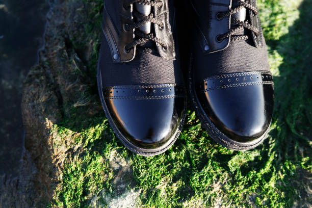 istock Fashionable black lace-up boots with patent toe 1299087170