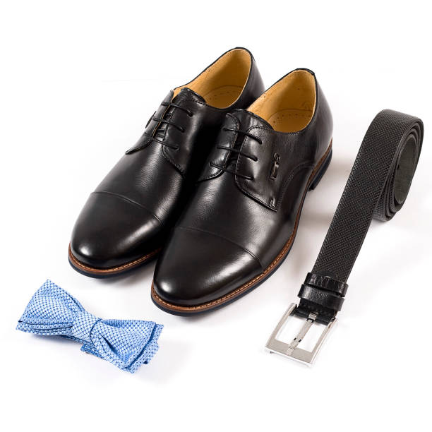 istock Men's leather shoes and belt on a white background 1299088355