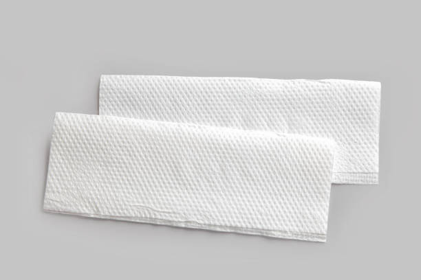 istock new white folded paper napkins on grey kitchen table background, top view 1299088600