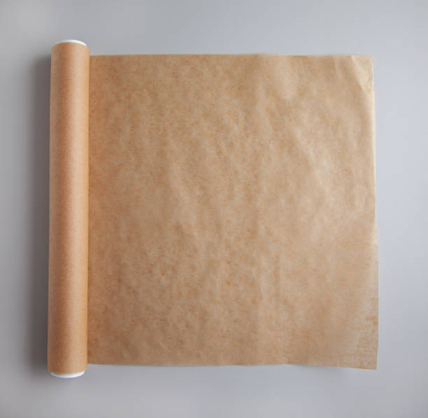 istock roll of brown baking paper on grey kitchen table, top view 1299088615
