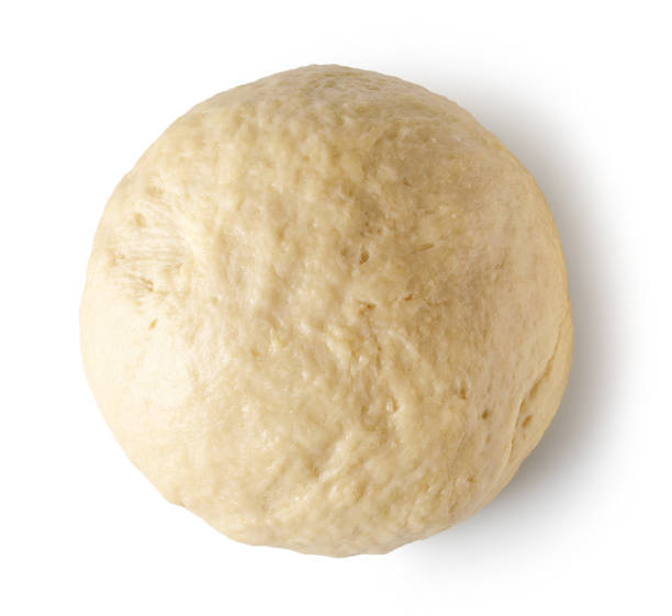 istock fresh yeast dough isolated on white background, top view 1299088624