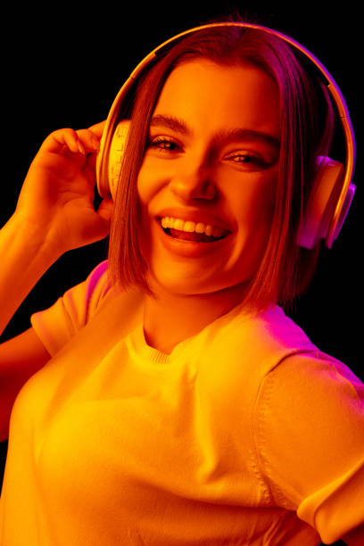istock Caucasian woman's portrait isolated on black studio background in multicolored neon light 1299090698