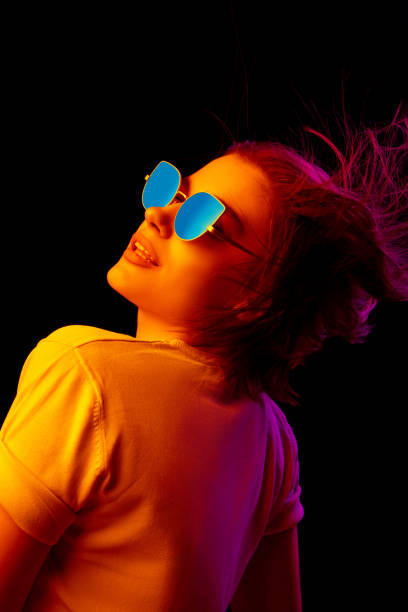 istock Caucasian woman's portrait isolated on black studio background in multicolored neon light 1299090758